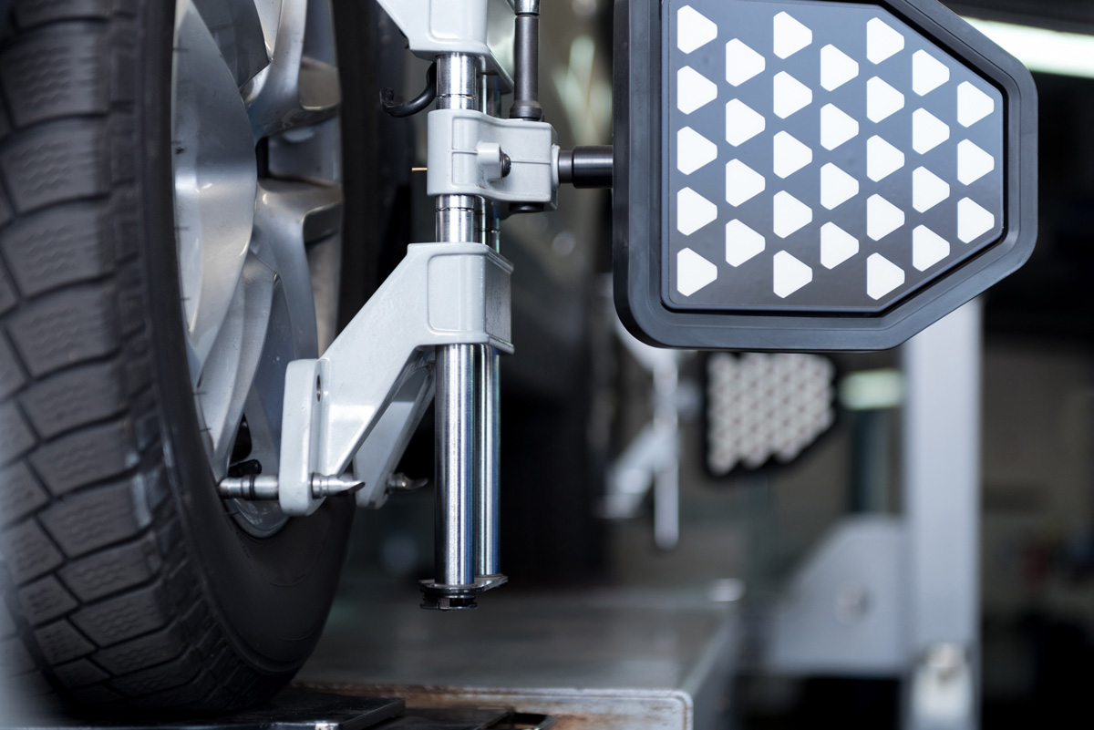 A wheel on a vehicle being aligned in an El Paso body shop.