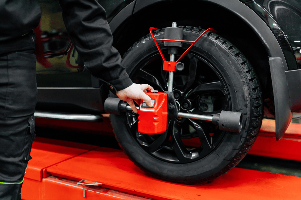 Mechanic aligning a car’s wheels